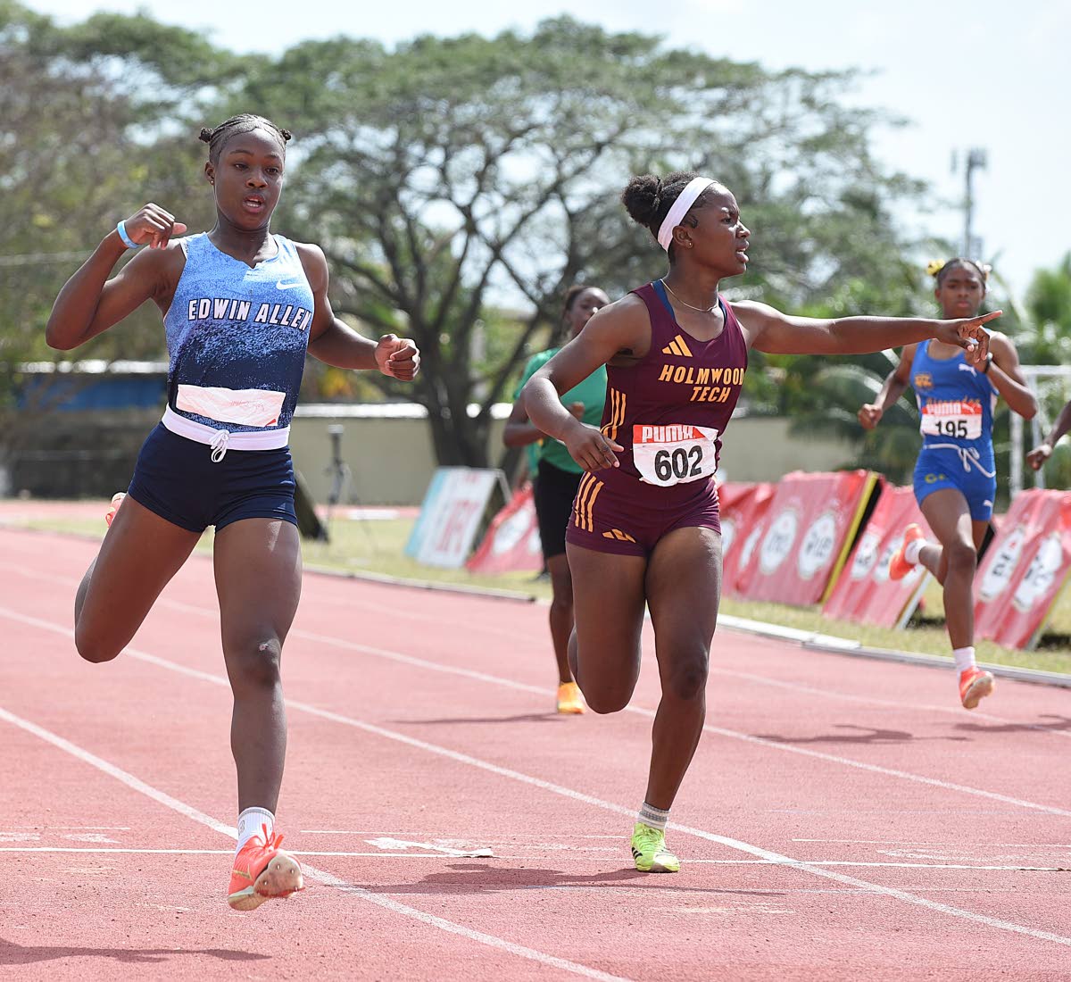 Edwin Allen High School’s Niesha Campbell (left) wins the Class 4 girls’ 200 metres in 25.25 seconds, finishing ahead of Holmwood Technical’s Phillippoa Gentles at the ISSA Central Athletics Championships at G.C. Foster College yesterday. 