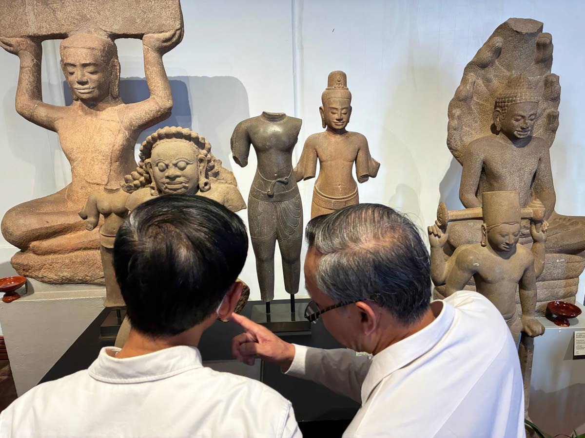 Cambodian officials look at Khmer cultural artefacts that were returned to the country, at the National Museum, in Phnom Penh.
