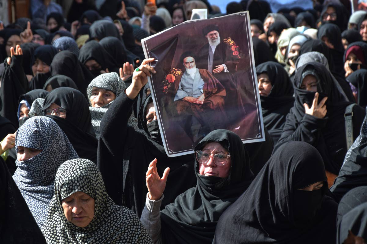 Shiite Muslims hold the portraits of Iranian leaders during a rally to condemn the killing of Iranian Supreme Leader Ayatollah Ali Khamenei, in Quetta, Pakistan, on March 1, 2026. 
