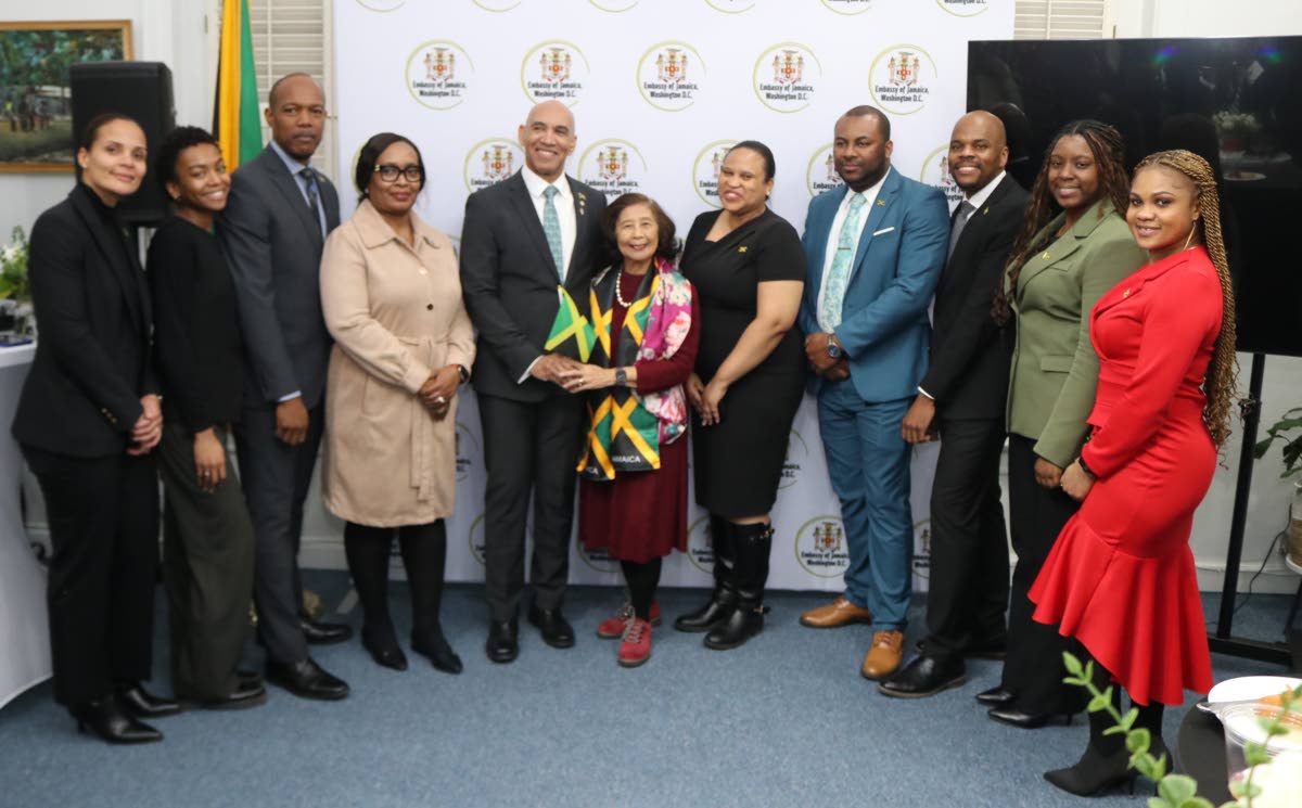 Jamaica’s Ambassador to the United States, Major General (Ret’d) Antony Anderson (fifth left) and Patricia ‘Miss Pat’ Chin (centre), co-founder of VP Records, with members of staff of the Embassy of Jamaica after she was honoured by the embassy at 