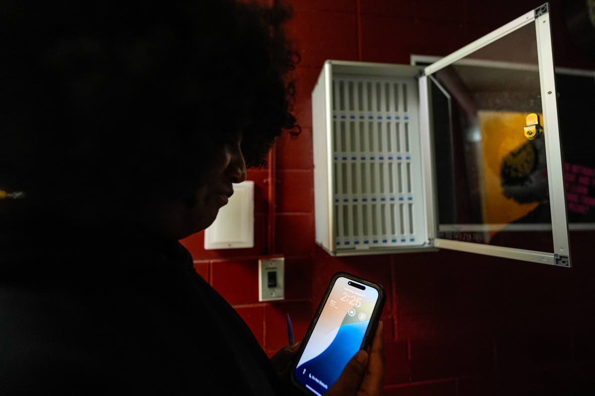 A student views her cell phone at Ronald McNair Sr High School in August 2025 in Atlanta. 