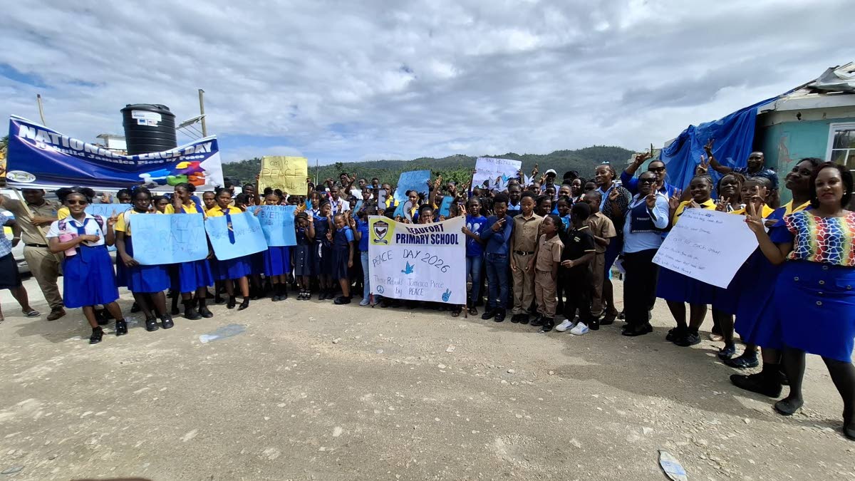 Students of Maud McLeod High School and Beaufort Primary School pose for a group photo after merging their Peace Day activities at the Darliston bus park in Westmoreland.