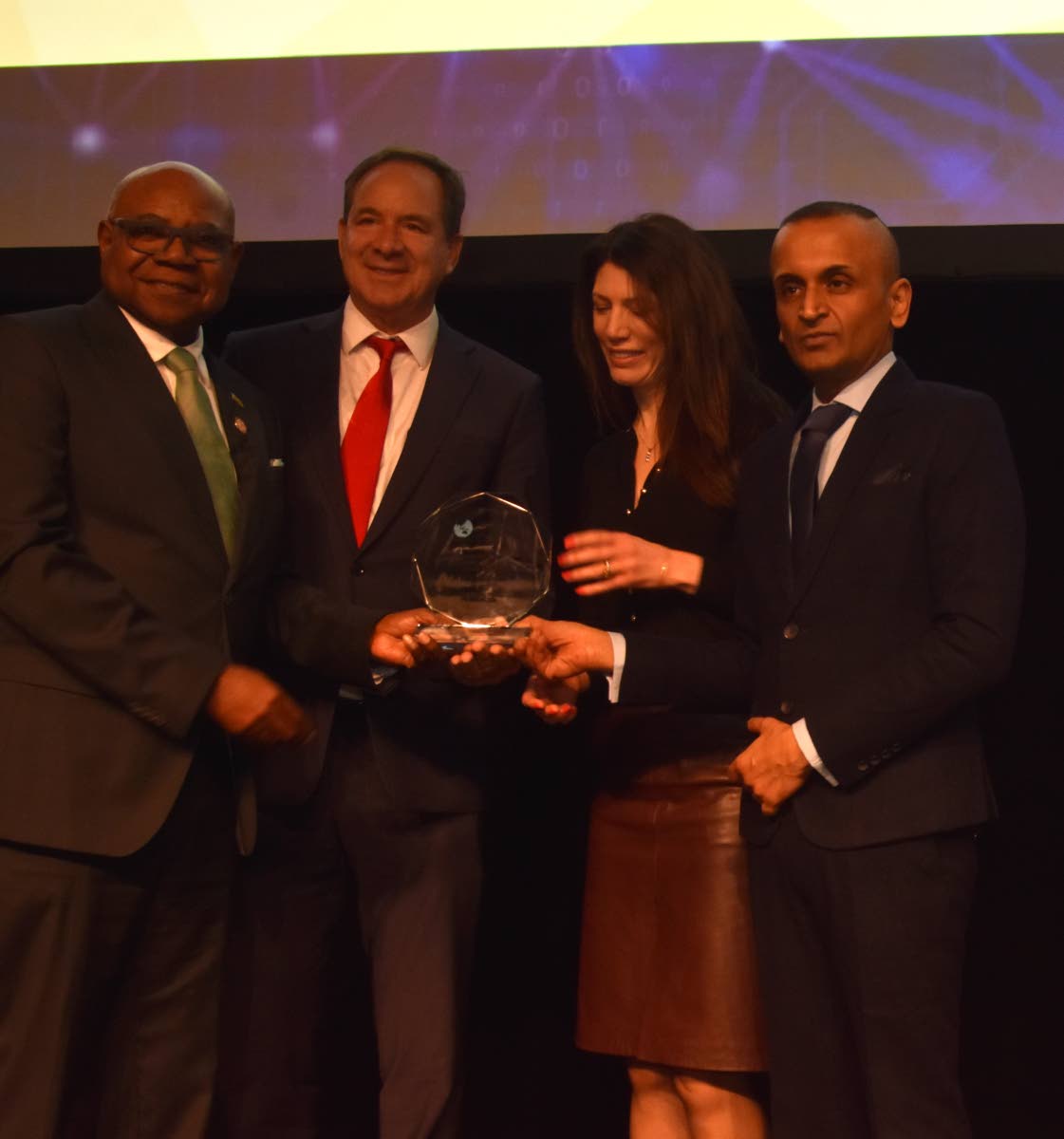 Jamaica’s Minister of Tourism, Edmund Bartlett (left), shares a moment with S Hotel’s CEO Christopher Issa, the company’s UK representative Victoria Cranmer, and PATWA Secretary General Yatan Ahluwalia during the awards presentation at ITB Berlin in 