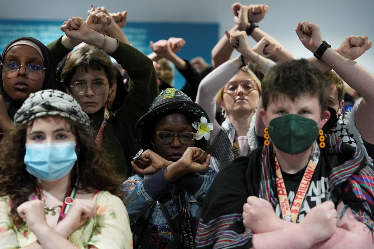 Activists demonstrate in silence, protesting a draft of a proposed deal for curbing climate change at the COP29 UN Climate Summit, Friday, November 22, 2024, in Baku, Azerbaijan. 