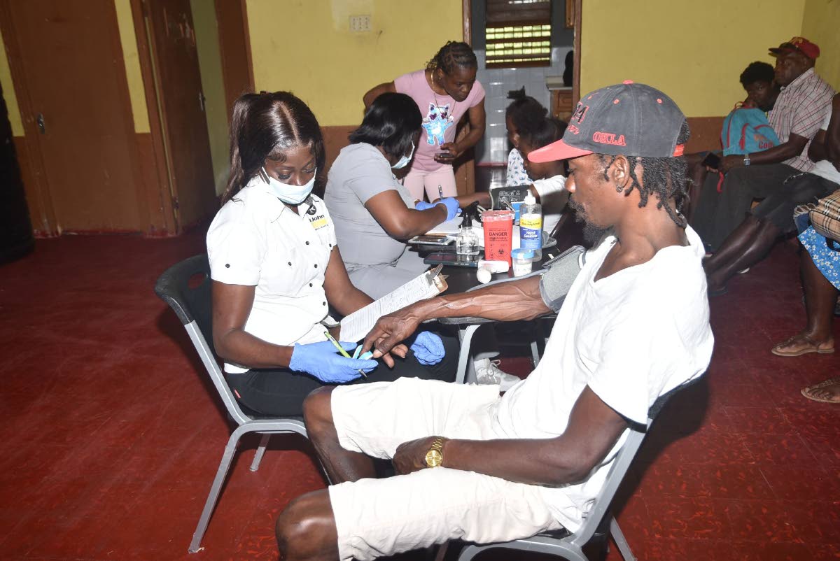 Representatives of St John Ambulance check the vitals of community members at Balaclava in St Elizabeth.