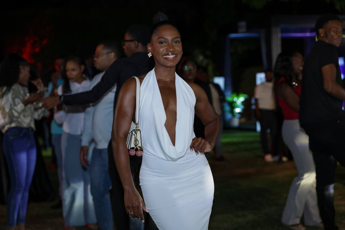 Dr Ashleigh Nicole Brown stuns in a deep-plunge white dress.