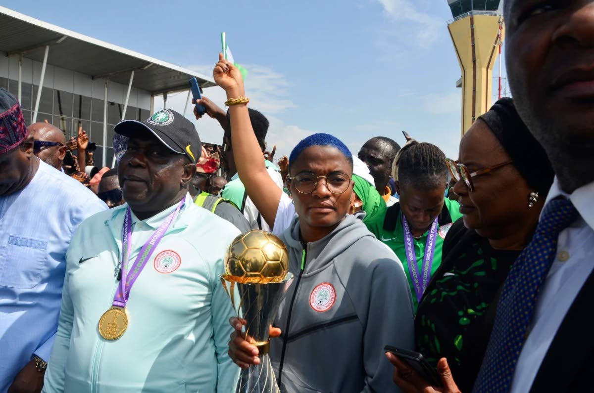Nigeria’s captain Rasheedat Ajibade (centre) holds the Women’s African Cup of Nations trophy upon arrival at the Nnamdi Azikiwe International airport in Abuja Nigeria, Monday, July 28, 2025.