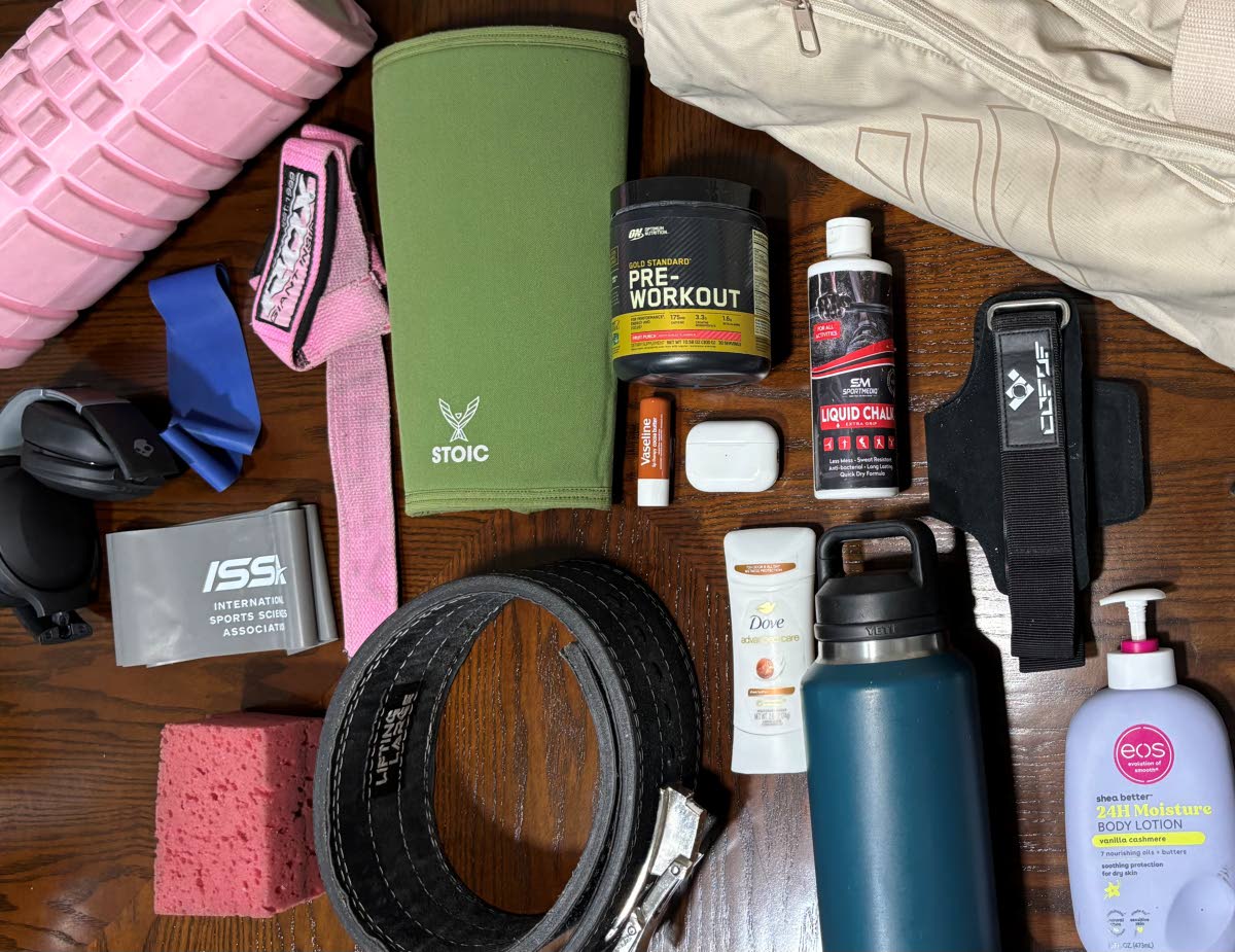 A look inside Alexa Williams’ gym bag reveals her training essentials, including resistance bands, pre-workout supplements, liquid chalk, a lifting belt, headphones and a Yeti water bottle — items she relies on to power through workouts.