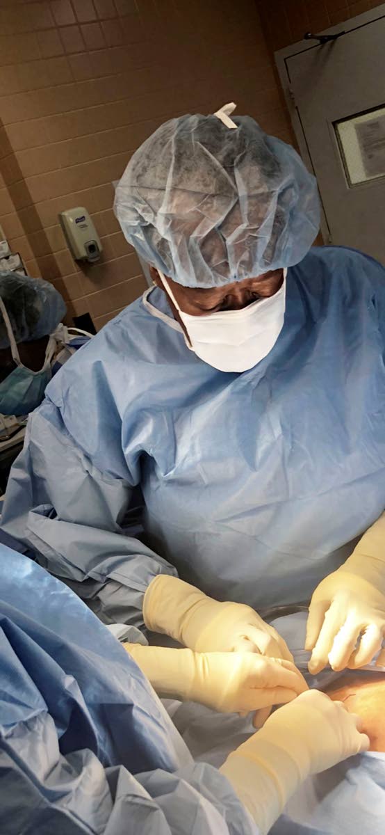 
Dr Millicent Comrie goes to work on a patient at the Maimonides Medical Center, Brooklyn, NY.