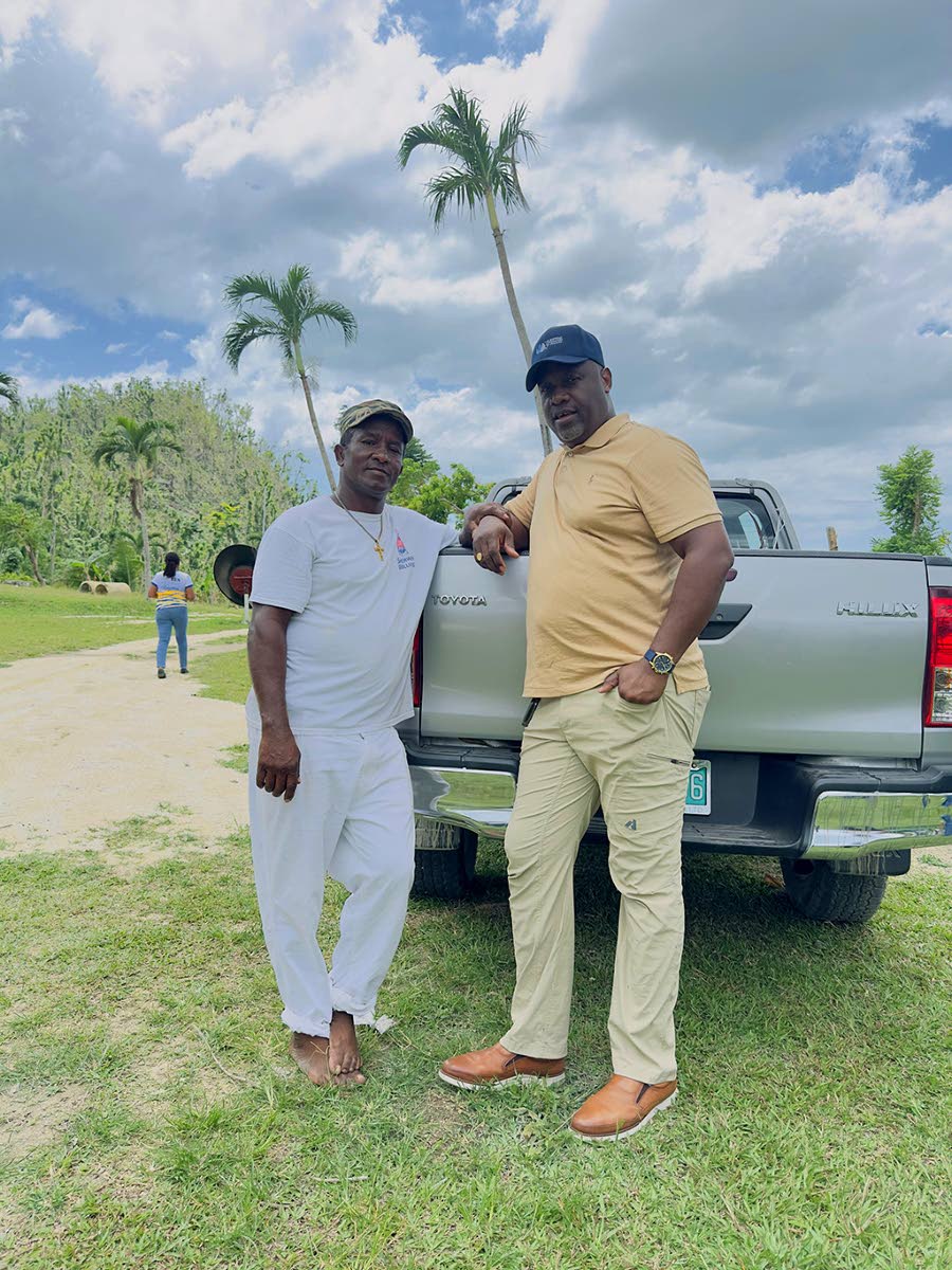 Terrence Brooks with Westmoreland resident Johnathon Headley who assisted with package distributions on Saturday.