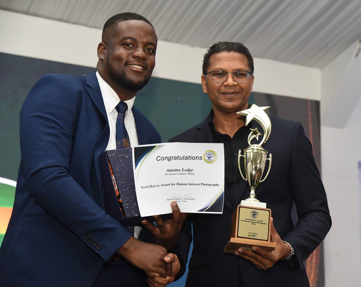 The Gleaner’s Antoine Lodge receives the Errol Harvey Award for Human Interest Photography from Richard Pandohie, group CEO at Seprod.