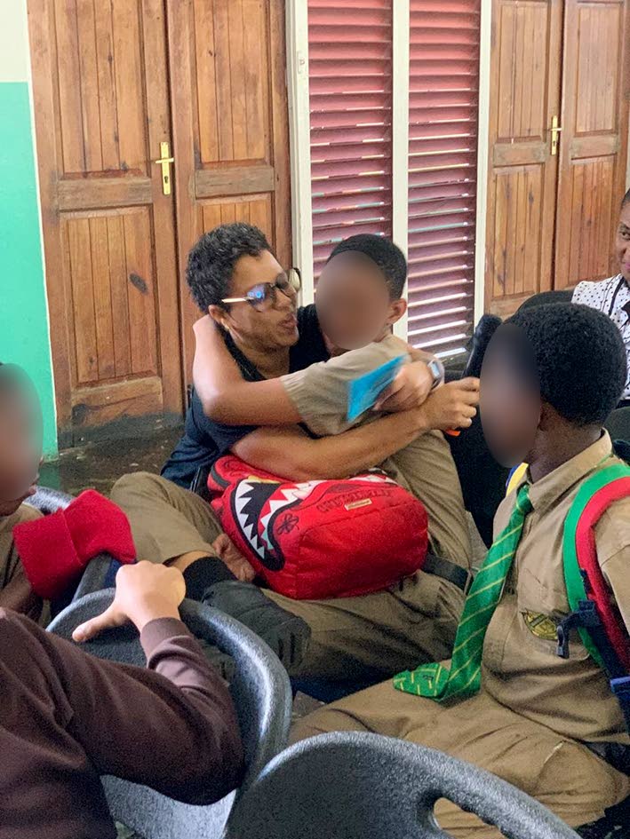 Students of Belair High School being embraced by their parents. 