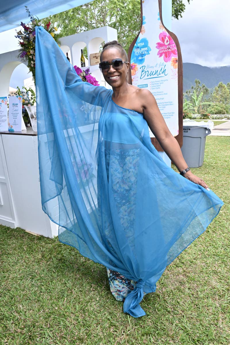 Debra Taylor-Smith, luxury portfolio manager at Select Brands Limited, is a vision in blue, striking a playful pose for the camera.