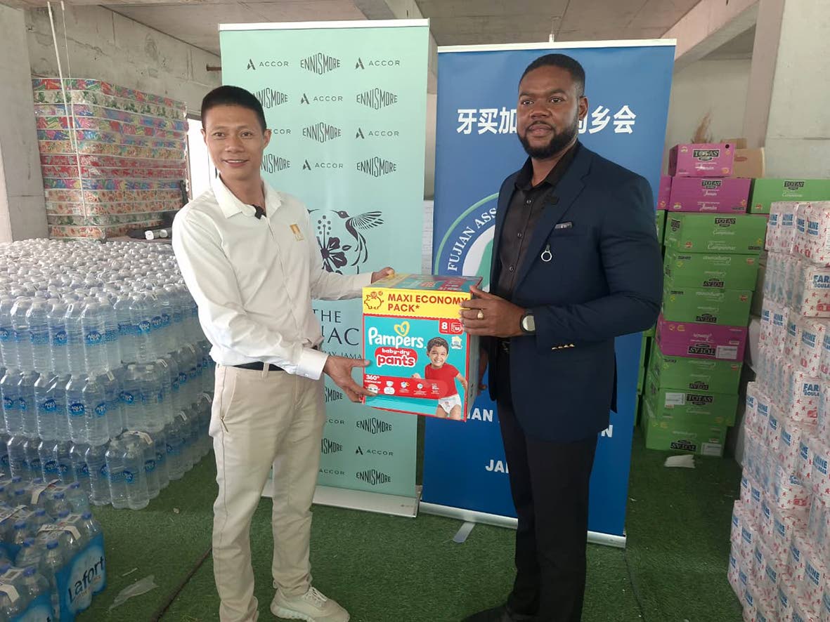 Yangsen Li, vice-president of the Fujian Association of Jamaica, presents hurricane relief supplies on behalf of the Chinese business community in Guadeloupe to Richard Vernon Jr, mayor of Montego Bay.