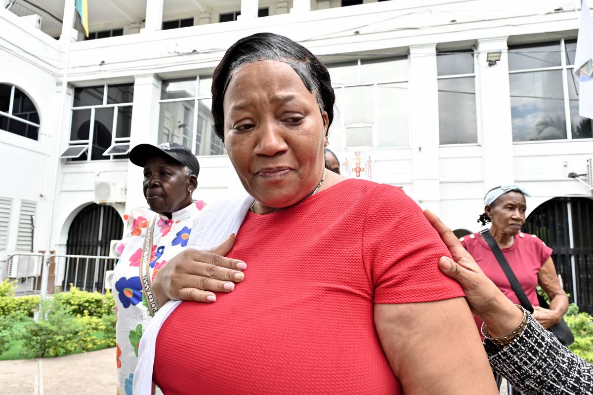 Sophia Lugg (centre), the mother of Donna-Lee Donaldson, speaks with the media after leaving the Supreme Court in downtown Kingston yesterday.