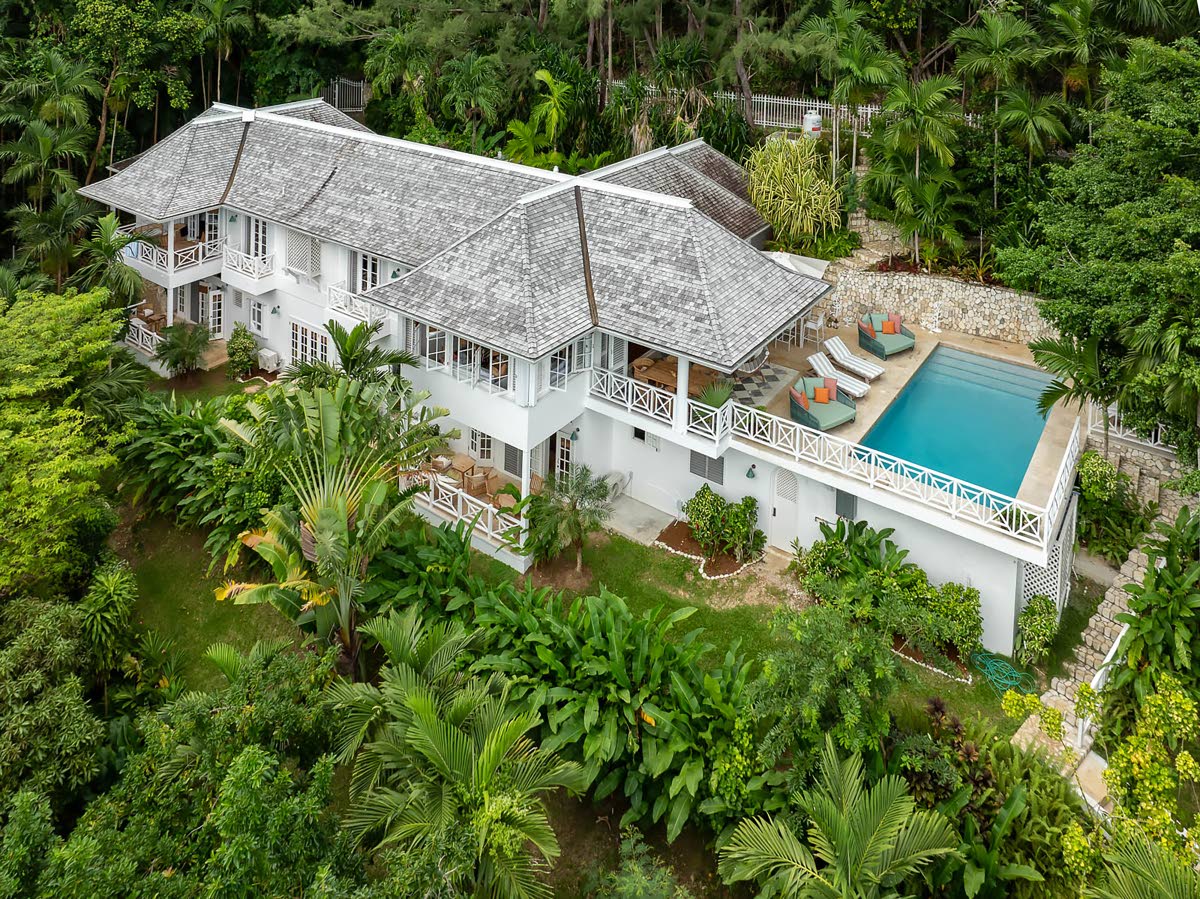 A celebrity villa nestled within extensive greenery and a bird sanctuary.
