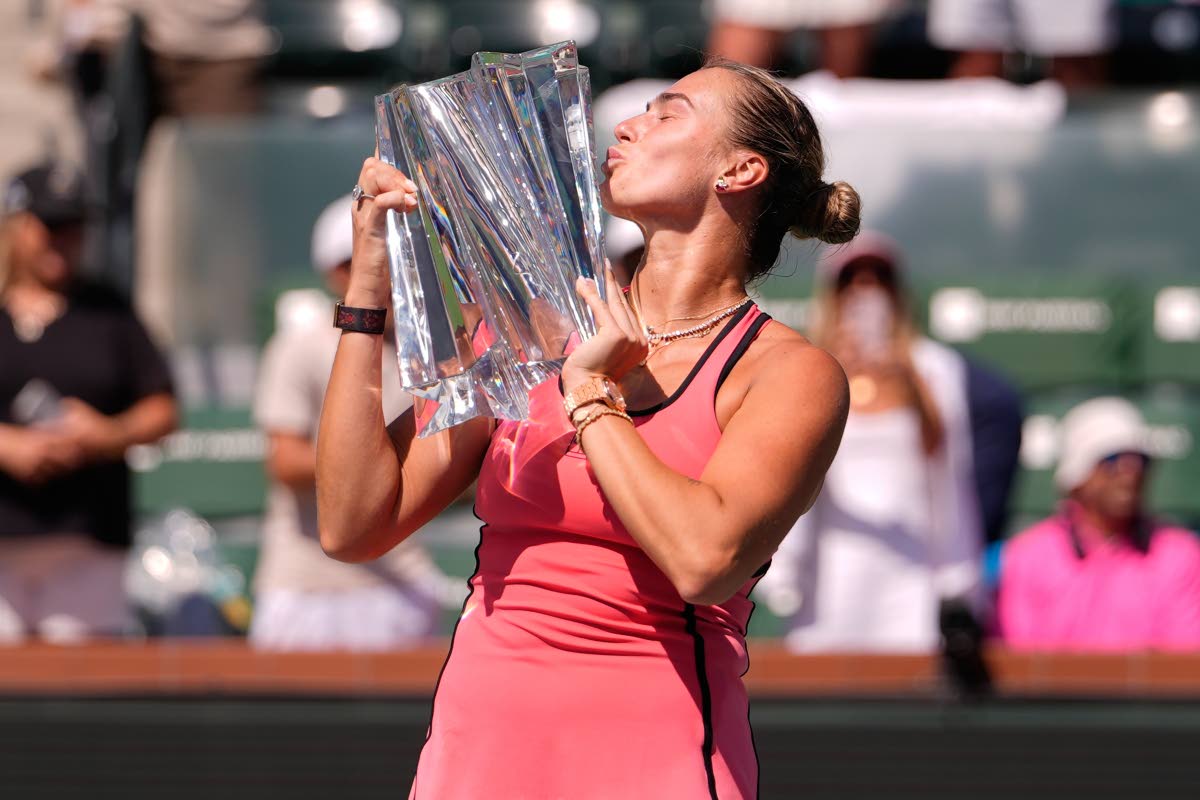 Aryna Sabalenka, of Belarus, kisses the winner's trophy after defeating Elena Rybakina, of Kazakhstan, to win the BNP Paribas Open tennis tournament Sunday, March 15, 2026, in Indian Wells, California.
