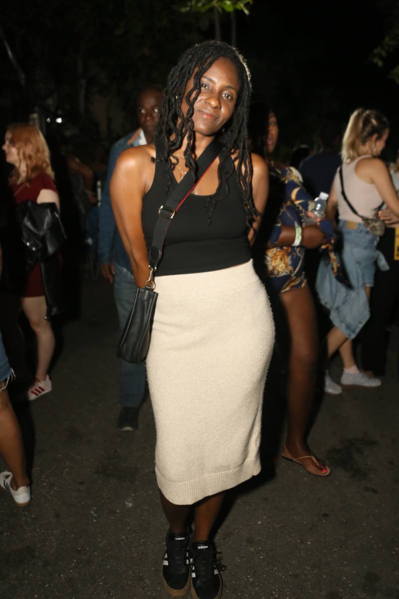 Reggae singer Jah9 keeps it casual and comfortable offstage in a black tank and black-and-white low tops.  