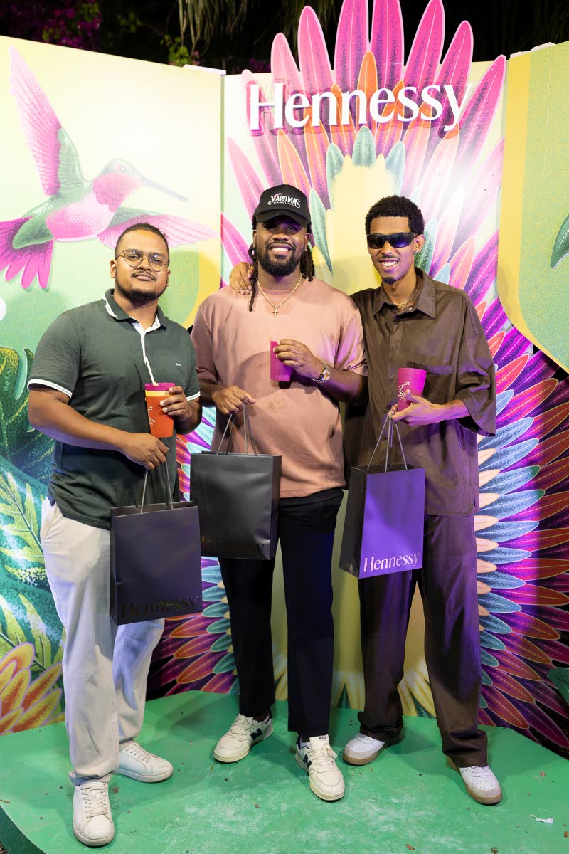 From left: Keanu Laing, business analyst, JMMB Group; Event Director Shaquille Blake; and musician Zac Jone$ show off their Hennessy carnival goody bags, filled with essentials.