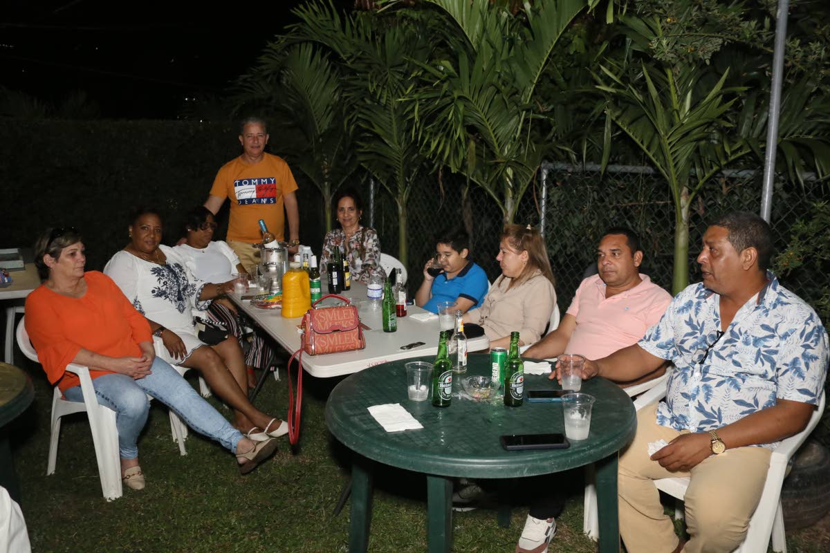 Cuban medics and their families in relaxed conversation during the farewell party. 