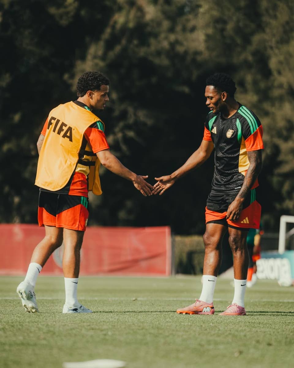 Reggae Boyz Bailey Cademarteri (left) and Renaldo Cephas greet each other during a training session in Mexico. 