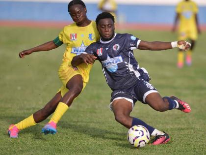 
Jamaica College’s Donald Stewart (right) and St Mary’s College’s Shaquille Burgher jostle for possession during their ISSA/WATA Manning Cup game at the Ashenheim Stadium yesterday. 