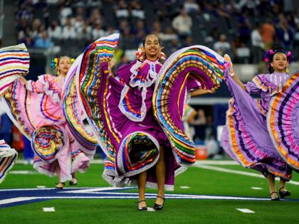 A folklorico dance group performs at half-time of an NFL football game between the Baltimore Ravens and Dallas Cowboys in Arlington, Texas in September 2024.
