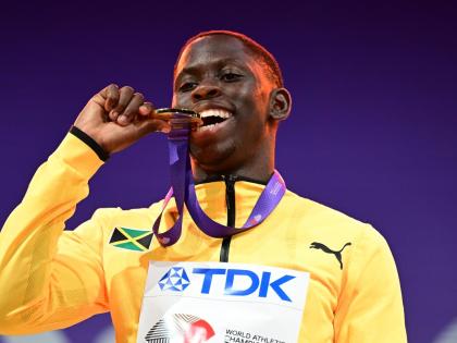 Jamaica’s Oblique Seville tests the authenticity of the gold medal he earned for winning the 100 metres at the World Athletics Championships in Tokyo, Japan.
