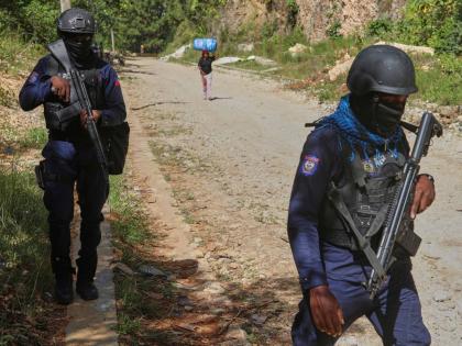 Police officers patrol the area near the Sainte-Hélène orphanage in the Kenscoff neighbourhood of Port-au-Prince, Haiti.