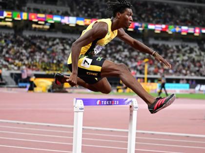 Jamaica’s Roshawn Clarke cleares a hurdles during his me’s 400-metre hurdles heat at the World Athletics Championships inside the Japan National Stadium in Tokyo yesterday. 