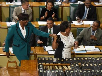 Juliet Holness (left) was escorted to take the Oath of Office by former House Speaker Marisa Dalrymple-Philibert after she was elected as Speaker of the House of Representatives.