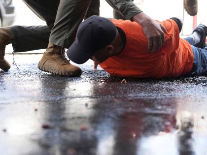 A man is detained by immigration agents at a car wash on Friday, August 15, 2025, in Montebello, California.