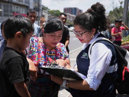 A relative of an unaccompanied minor deported from the United States reviews the list of those deported outside La Aurora International Airport, in Guatemala City on August 31.