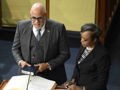 House Clerk Colleen Lowe (right) administers the oath of allegiance as Keith Duncan is sworn in as a government senator in Gordon House on Thursday.