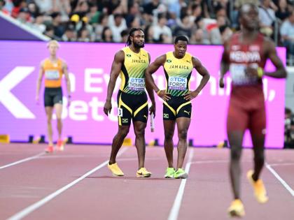 World Championships silver medallist Kishane Thompson (left) and teammate Ryiem Forde walk to the finish line, dejected men, after dropping the baton in the men's 4x100-metre heats.
