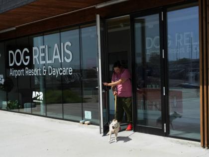 A costumer walks with her dog as she leaves the Dog Relais, a hotel for dogs at Rome’s Fiumicino International Airport.