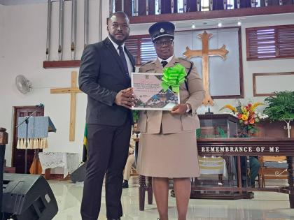 Superintendent of Police Mercedes Currie (right), acting commanding officer for the St James Police Division, receives a presentation from Oraine Ebanks, principal of Green Pond High School in Montego Bay, St James, during a church service held by the Jama