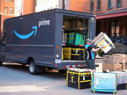 An Amazon Prime driver makes a delivery outside an apartment building in Pittsburgh, March 10, 2025.