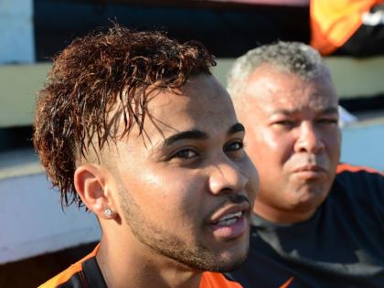 Kyle Butler (left) speaks as his father Craig looks on in the background.