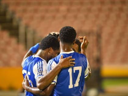 Mount Pleasant Academy players celebrate Ranaldo Biggs’ goal against O&M Football Club during Concacaf Caribbean Cup match  at the National Stadium on September 30.