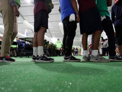 Immigrants line up in the dining hall at a new US government holding centre for migrant children in Carrizo Springs, Texas, on July 9, 2019. (AP Photo/Eric Gay, File)