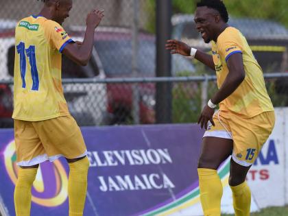 Molynes United’s Wisdom Ubani (right) and teammate Rashawn Livingston celebrate after Ubani scored his second goal against Spanish Town Police FC during their Jamaica Premier League match yesterday.