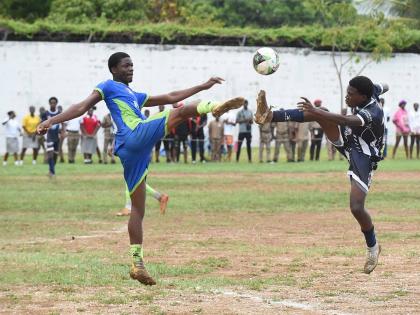 Vauxhall High School’s Serani Brown (left) and Jamaica College’s Gervair Grant fight for possession duing their ISSA/WATA Manning Cup Zone C clash at Vauxhall on Friday. The game ended 1-1.