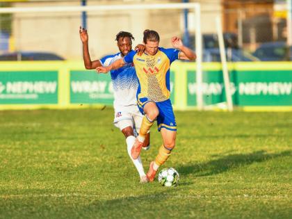 Dunbeholden’s Nicholas Nelson (left) challenges Harbour View’s Alexander Jacobs at the Jamaica Premier League at Drewland yesterday. Harbour View 1-0.