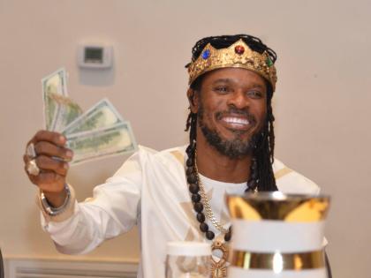 DJ-turned-Maroon-Emperor LA Lewis is all smiles as he shows part of the contribution collected by Owhe during the launch of the amended constitution at the ballroom of The Jamaica Pegasus hotel in New Kingston.