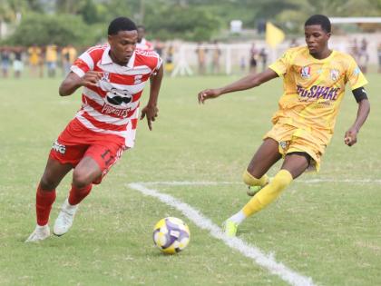 Glenmuir High School’s Orel Miller (left) outpaces Garvey Maceo’s Tyreek McKenley during their Zone I ISSA daCosta Cup  match at Glenmuir on October 8. Garvey Maceo came from two goals down to win 3-2. 