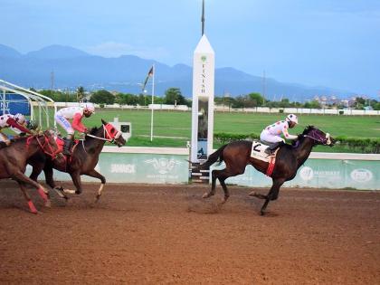 UNSPUN (right), ridden by Reyan Lewis, wins the Typewriter Trophy feature event ahead of INTRESTNTIMESAHEAD (Shane Ellis) at Caymanas Park on September 28.