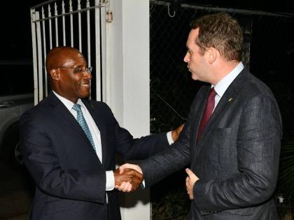 Minister of Industry, Investment and Commerce, Senator Aubyn Hill (left), greets Deputy British High Commissioner to Jamaica, Jonathan Cook, as he arrives at a welcome reception for the visiting United Kingdom Trade Mission to Jamaica on Wednesday, October