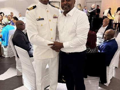 Commander Paul Smith (left), Royal Canadian Navy, and Chris Campbell who was honoured at a retirement brunch on September 21.
