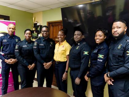 Paula-Anne Porter Jones (centre), communications specialist and lead instructor at PAP & Associates, stands with the ‘super six’ finalists of the 2025-2026 LASCO/JCF Saluting Our Heroes Awards. From left: Detective Corporal Livey Evans (non-geographica